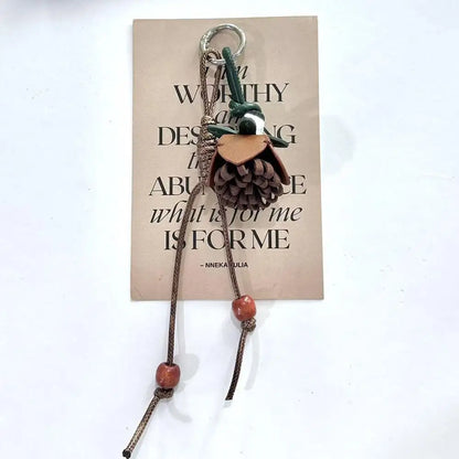 Breloque de sac à main avec pompon fleuri pour femme, porte-clés haut de gamme en cuir PU, pendentif en corde tressée avec pomme de pin et fleur.